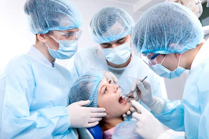 Image of doctors checking patient teeth